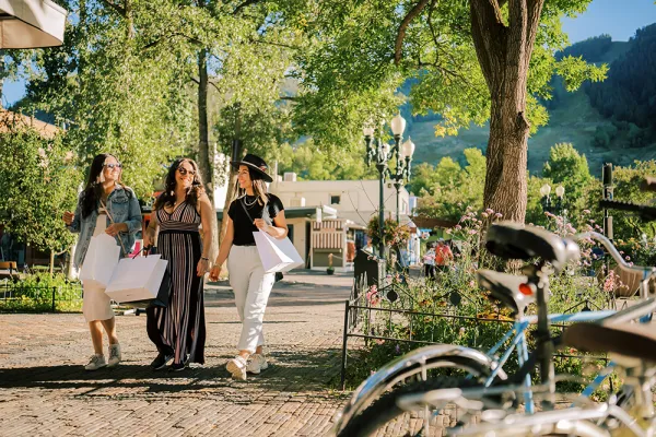 Women walking around downtown Aspen with shopping bags.